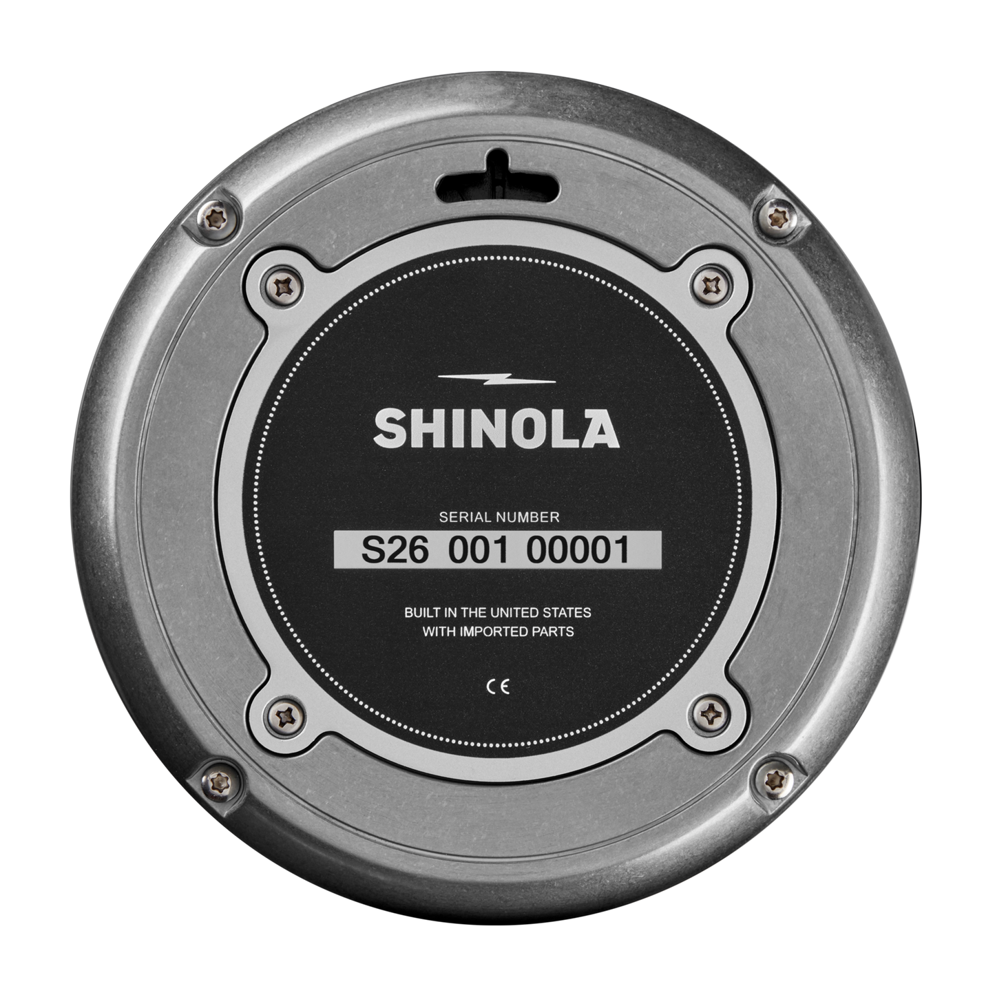 A close-up of the Shinola 14" Runwell Clock - Tumbled Zinc/Black back shows the logo, serial number S26 001 00001, and the text "Built in the United States with imported parts" on its black and silver tumbled zinc case.