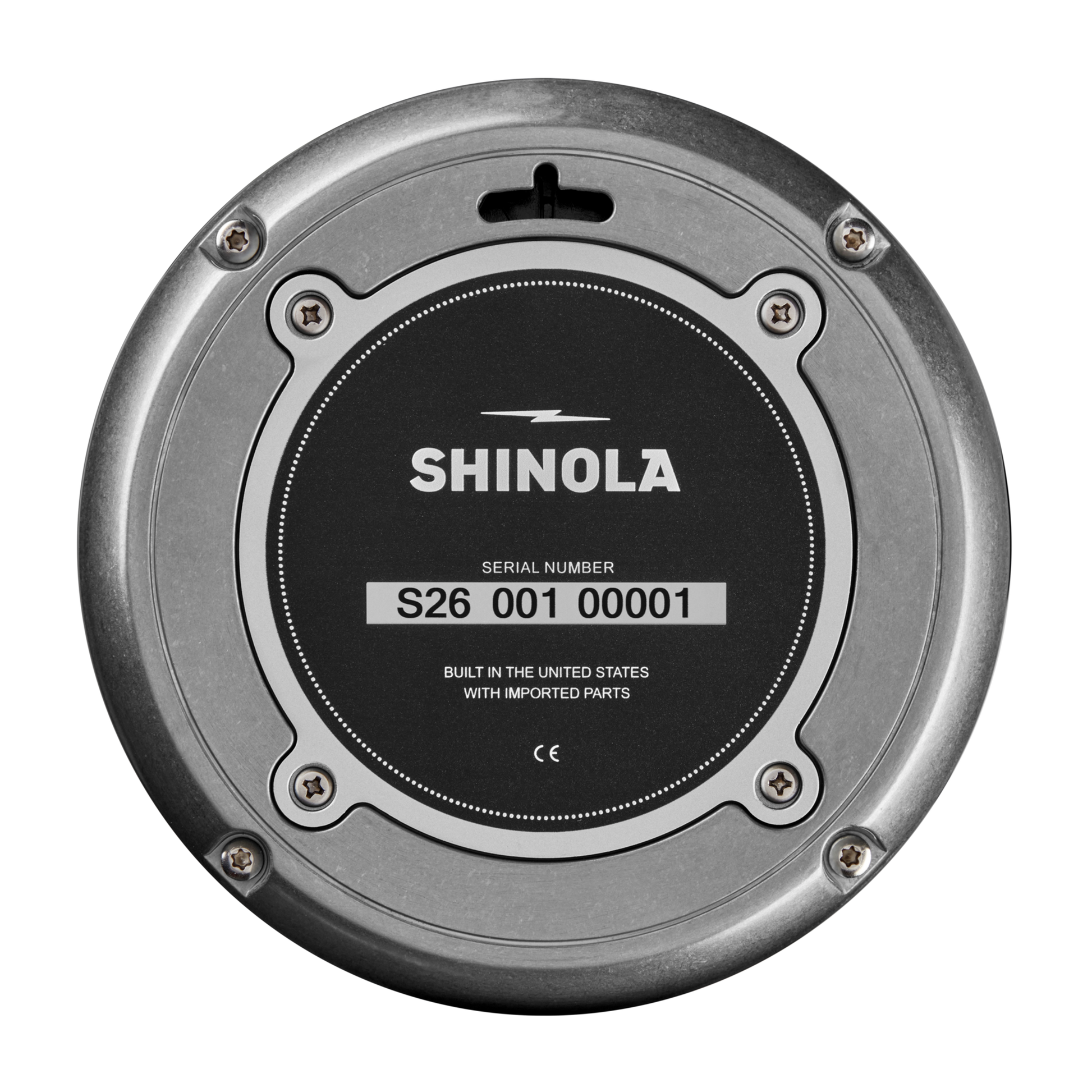 A close-up of the Shinola 14" Runwell Clock - Tumbled Zinc/Black back shows the logo, serial number S26 001 00001, and the text "Built in the United States with imported parts" on its black and silver tumbled zinc case.