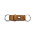 The Shinola Leather Valet Key Fob in brown features two silver metal rings on each end and a central snap button, showcased against a white background.