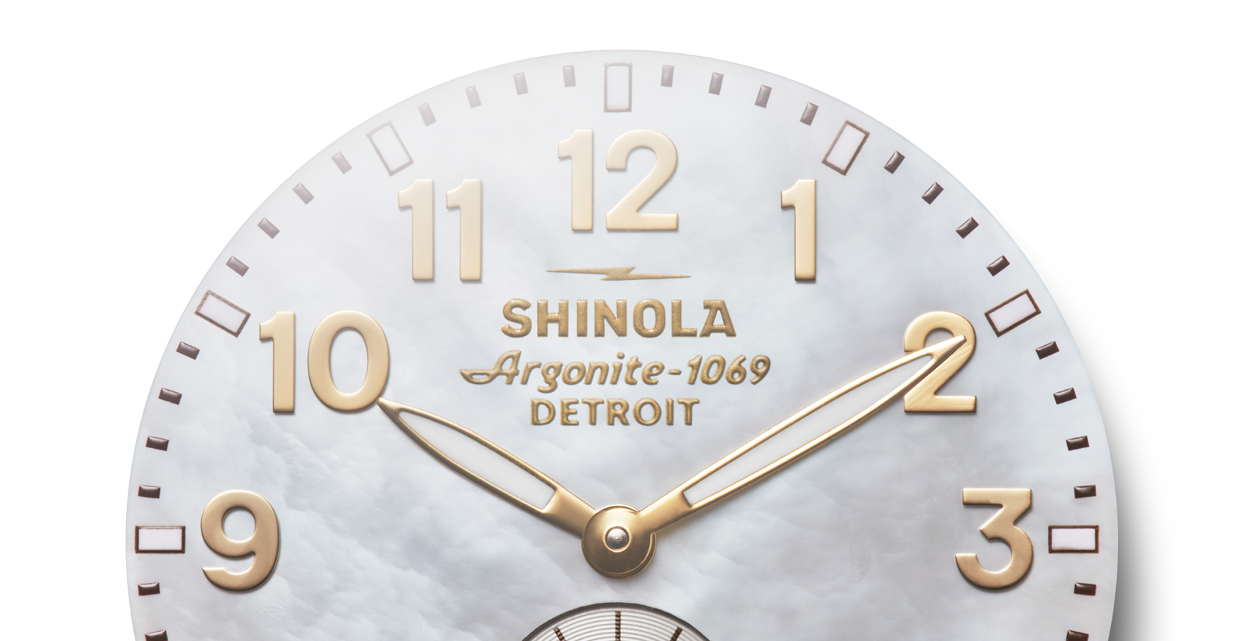 Close-up of a Shinola Runwell Watch - Mother Of Pearl showing 10:10, with gold-tone numbers and hands. The white marble-textured background complements its two-tone stainless steel bracelet.