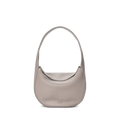 The Shinola Small Shoulder Bag - Taupe features a minimalist crescent-shaped design in premium leather with a wide strap, shown against a white background.