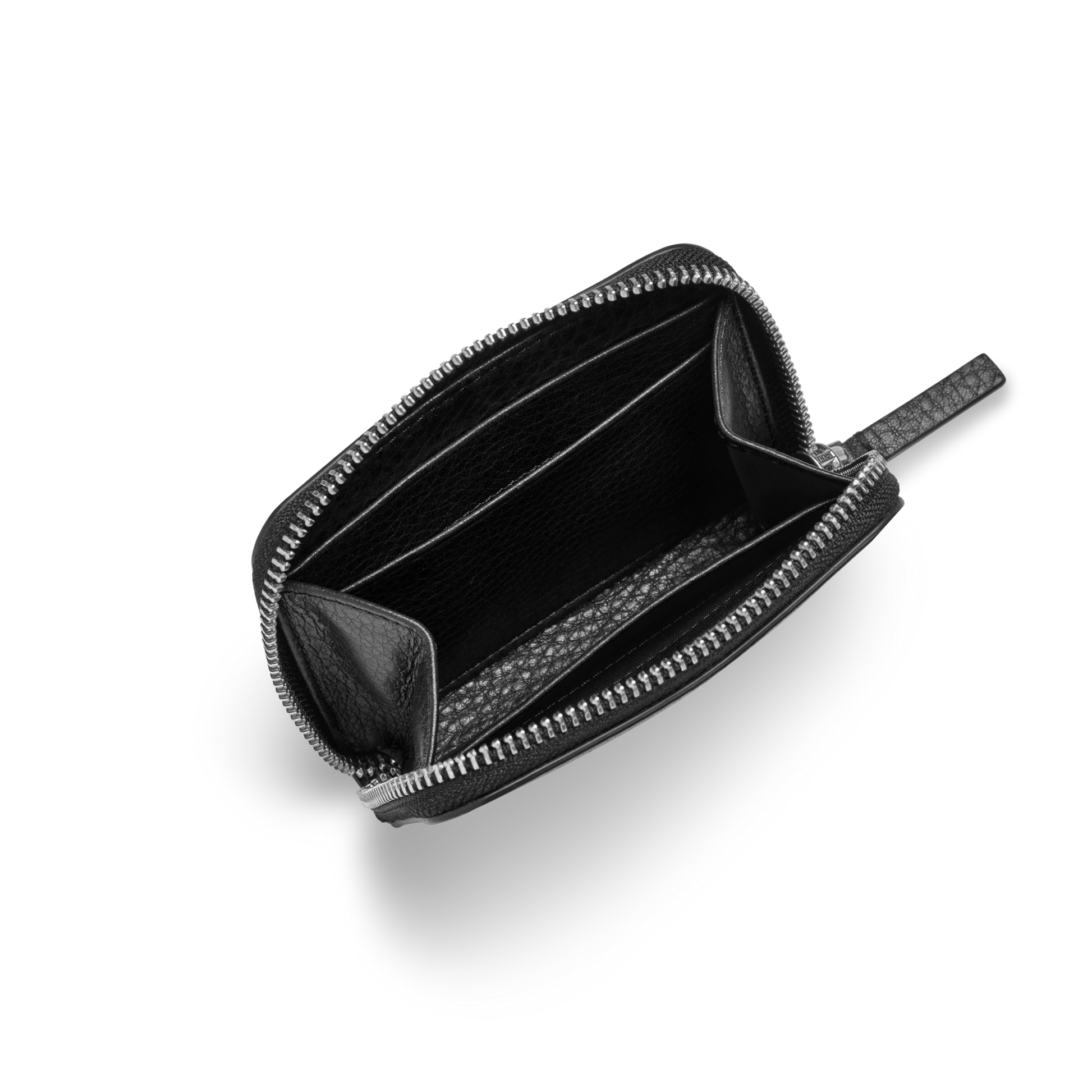 The Shinola Small Zip Wallet - Black, made from natural grain leather, is open on a light gray background showing its two main compartments and an interior divider. This compact wallet is empty and elegantly displayed.
