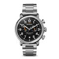 The Shinola Runwell Chronograph Watch - Black features a stainless steel case, black dial with white numerals, two stopwatch subdials, three silver pushers, and a metal link bracelet, shown on a white background.