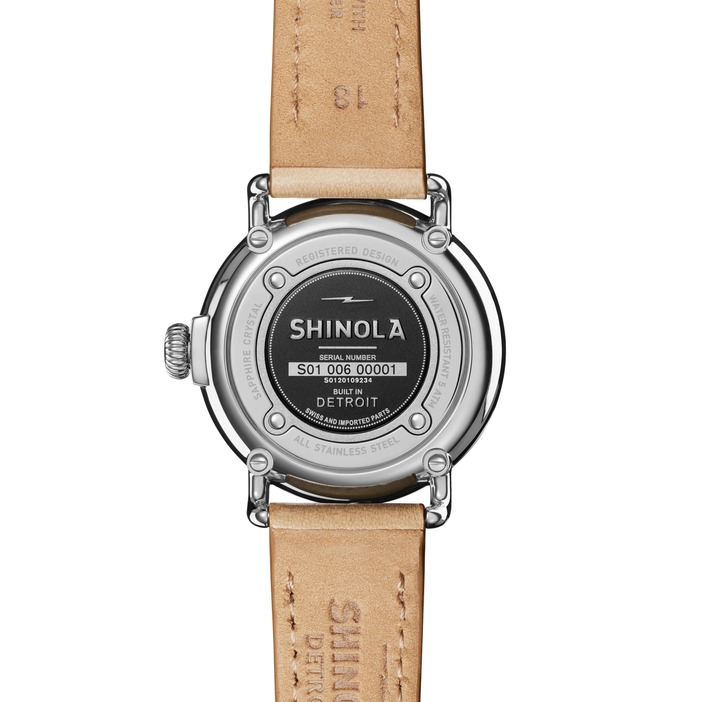 The back view of the Shinola Runwell Coin Edge Watch - Silver shows a round stainless steel case, black center with engravings, and tan leather strap, featuring the serial number and "Built in Detroit" inscription.