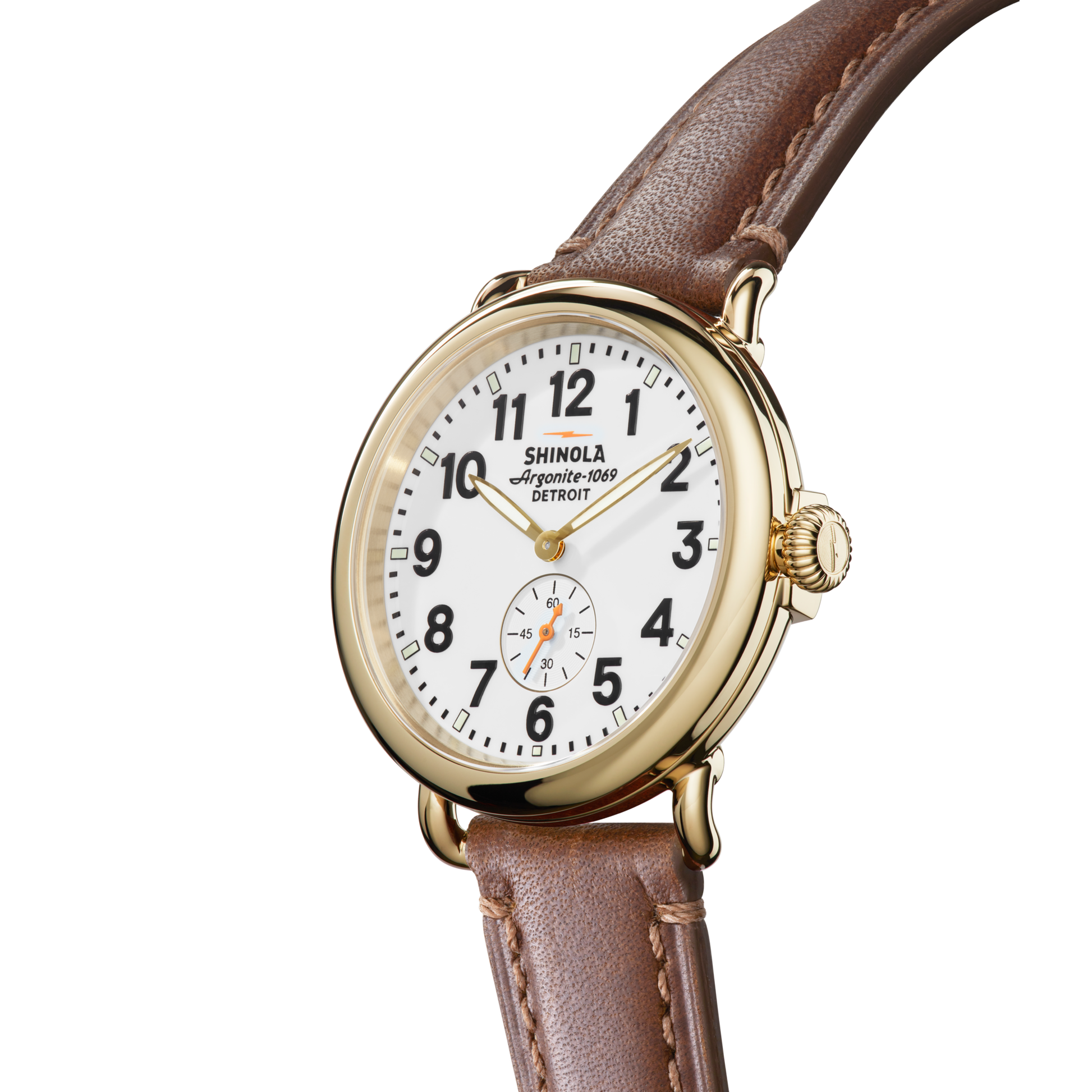 The Shinola Runwell Watch - White has a gold case, white face, black numerals, brown strap, and a small seconds subdial above 6 o’clock, shown on a plain white background.