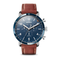 The Shinola Canfield Sport Chronograph Watch - Midnight Blue features a blue dial, brown leather strap, silver accents, chronograph function, date and day display, and sporty white Arabic numerals.