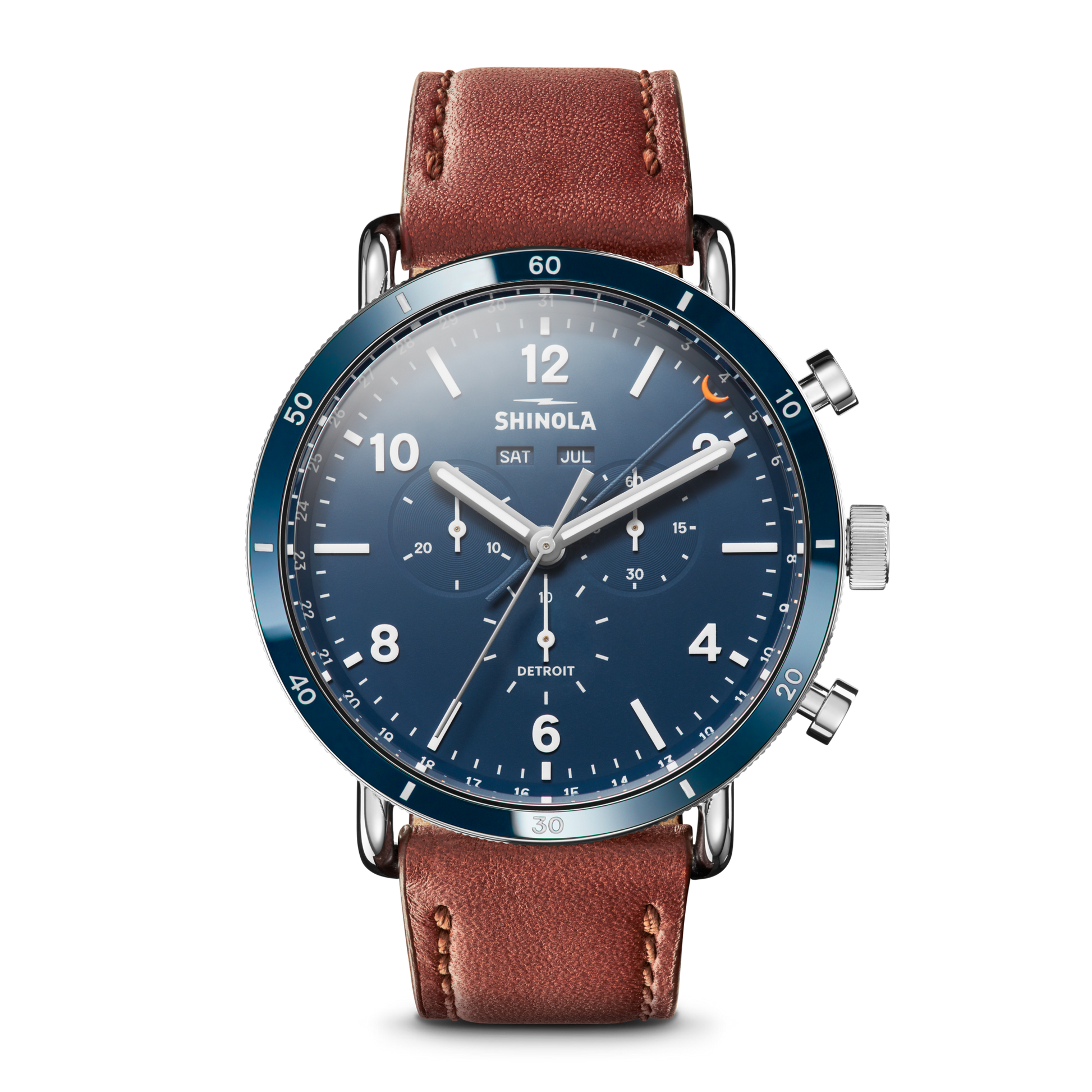 The Shinola Canfield Sport Chronograph Watch - Midnight Blue features a blue dial, brown leather strap, silver accents, chronograph function, date and day display, and sporty white Arabic numerals.
