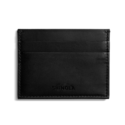 The Shinola 5 Pocket Card Holder in black vachetta leather features two horizontal card slots on one side and an embossed Shinola logo at the bottom center, shown against a plain white background.