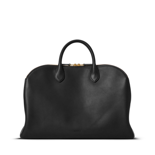 The Shinola Bixby Work Satchel - Black is crafted from natural leather with two top handles and a gold zipper, shown against a plain white background.