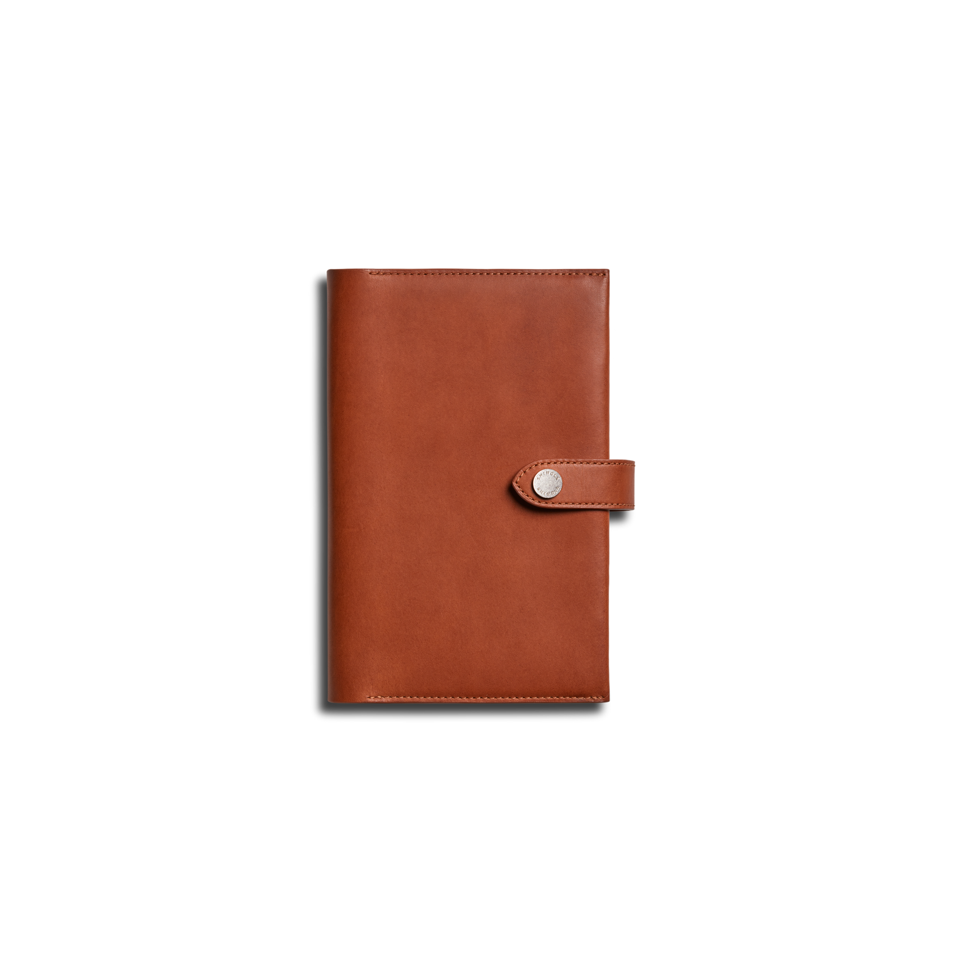 The Shinola Medium Snap Journal Cover in Rust is shown closed, featuring a strap and snap button closure, photographed against a plain white background.
