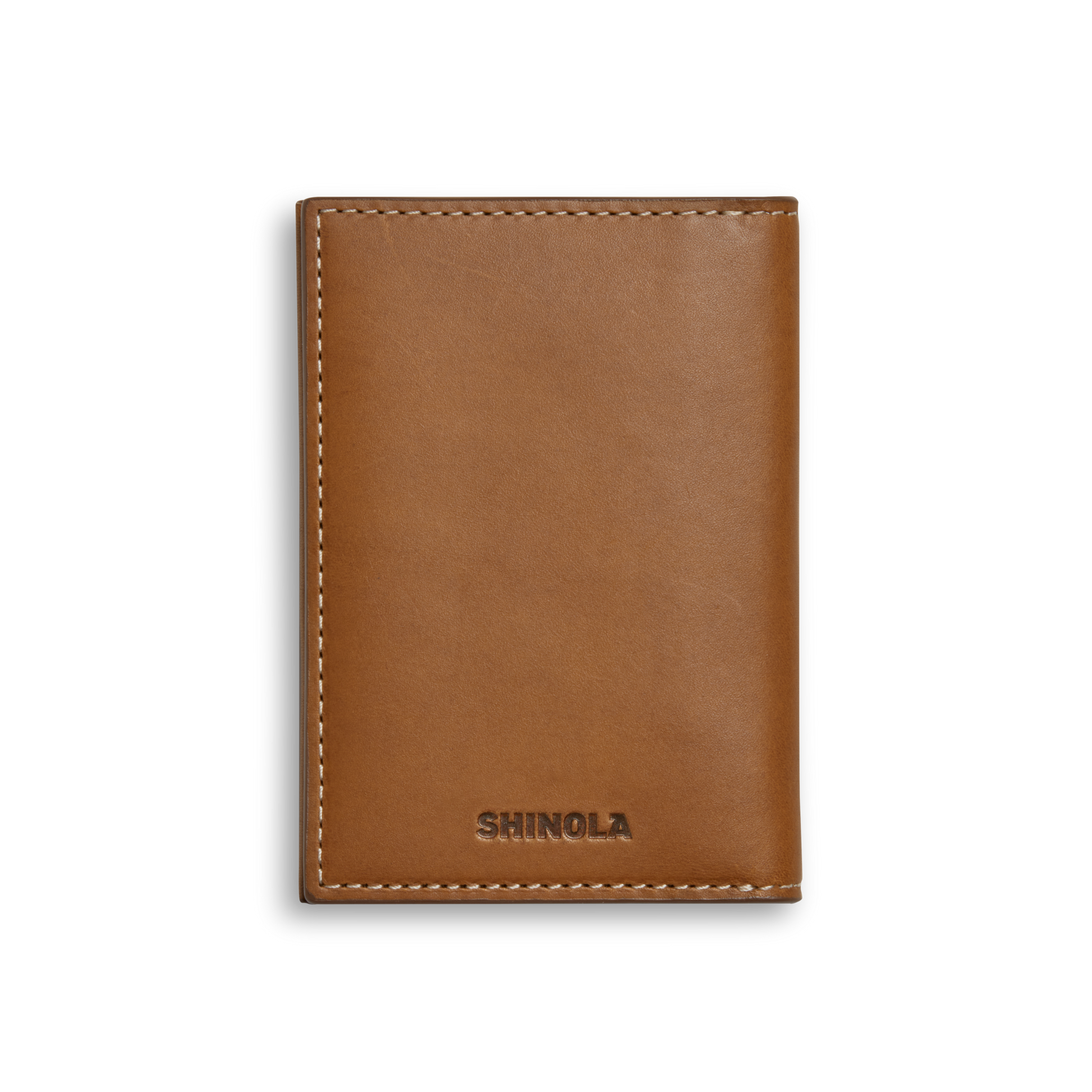 The Shinola Folded Card Holder Wallet in tan features Italian Vachetta leather, visible edge stitching, and "SHINOLA" embossed at the bottom center. This slim accessory combines elegance and practicality for your daily essentials.