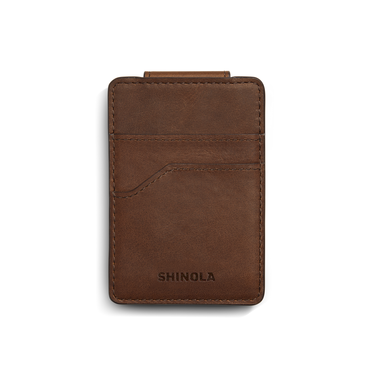 A medium brown Shinola Magnetic Money Clip Card Holder with visible stitching, two credit card slots, and the brand name embossed at the bottom, shown on a white background.