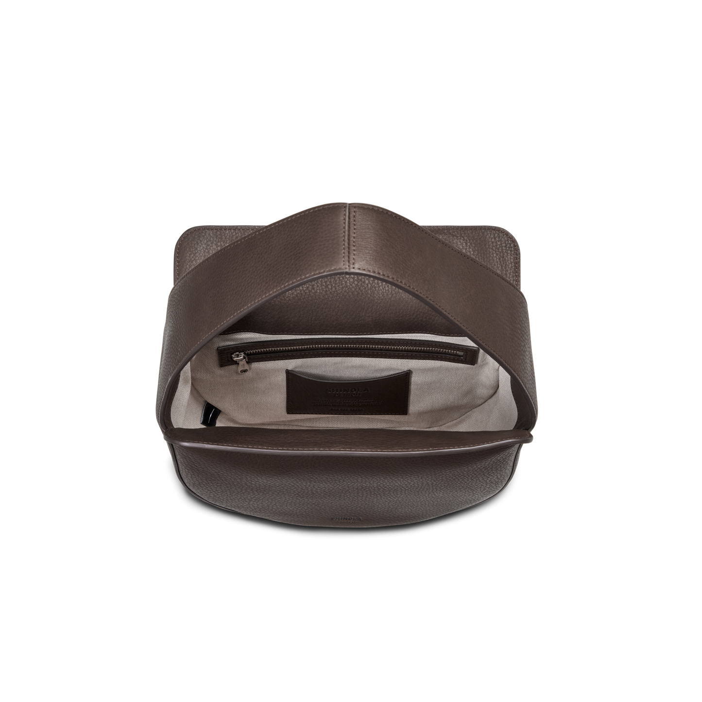 The Shinola Small Shoulder Bag - Espresso is shown open from above against a white background, revealing its brown natural grain leather, light interior lining, inner zippered pocket, and a small leather label inside.