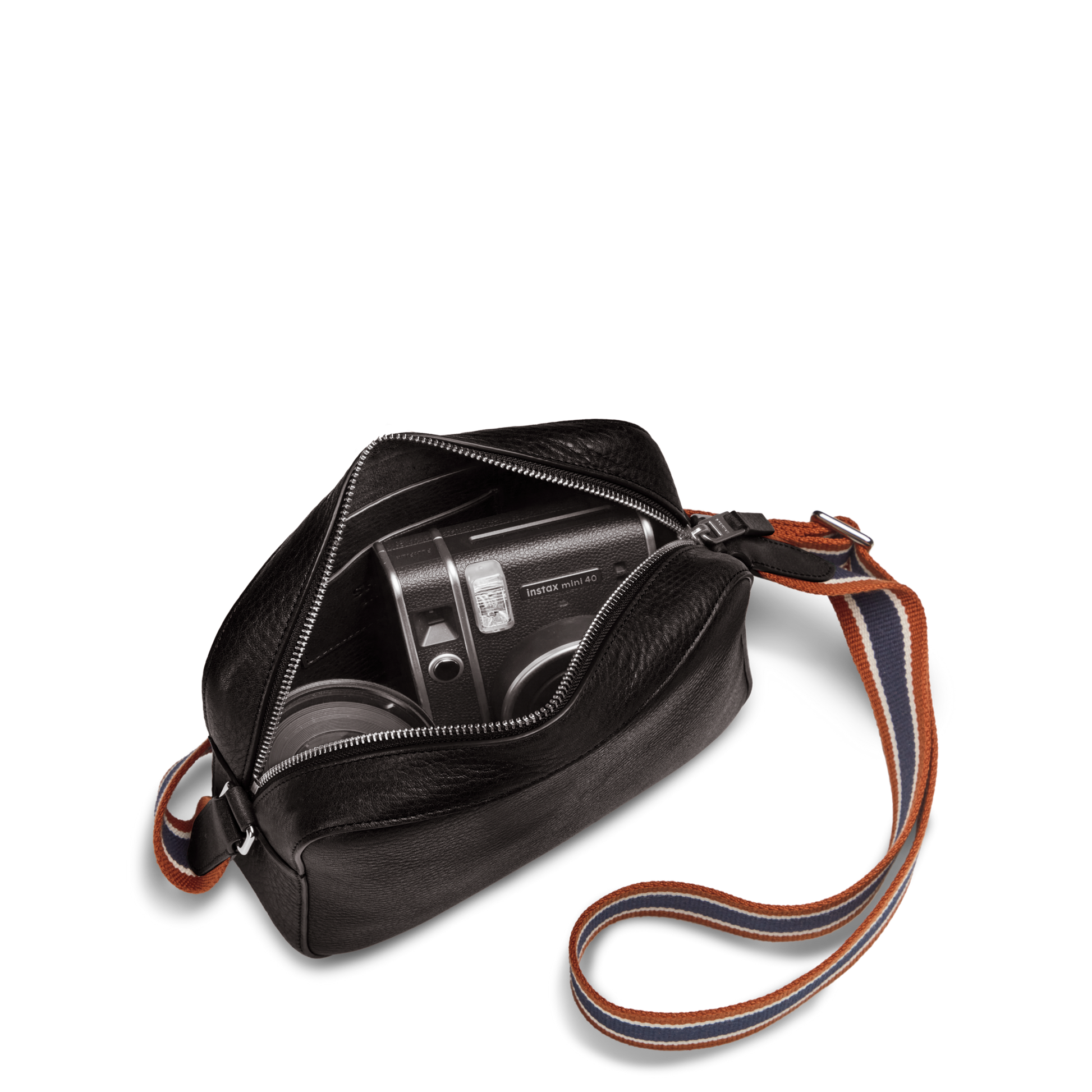 The Shinola Camera Crossbody Bag - Black, featuring an adjustable woven strap, is open to reveal a vintage camera inside. This leather day bag is displayed against a plain white background.