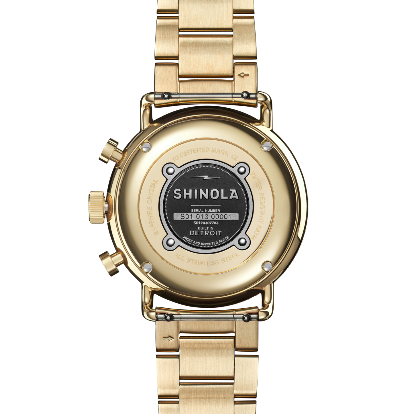 A Shinola Canfield Sport Watch - Gold Dominos is shown from the back, highlighting the engraved case back with brand name, serial number, and a sleek gold metal link bracelet.