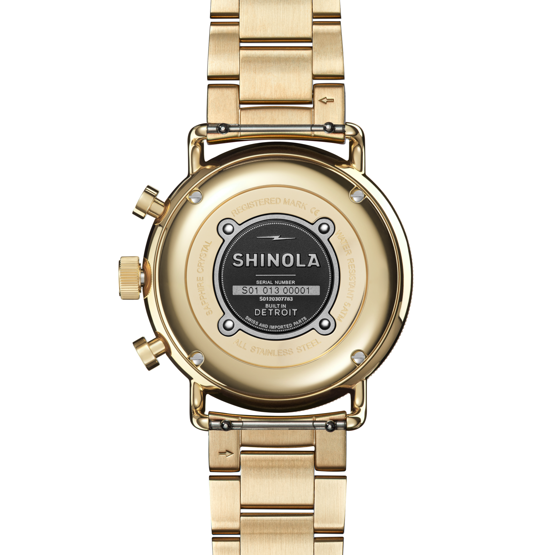 A Shinola Canfield Sport Watch - Gold Dominos is shown from the back, highlighting the engraved case back with brand name, serial number, and a sleek gold metal link bracelet.