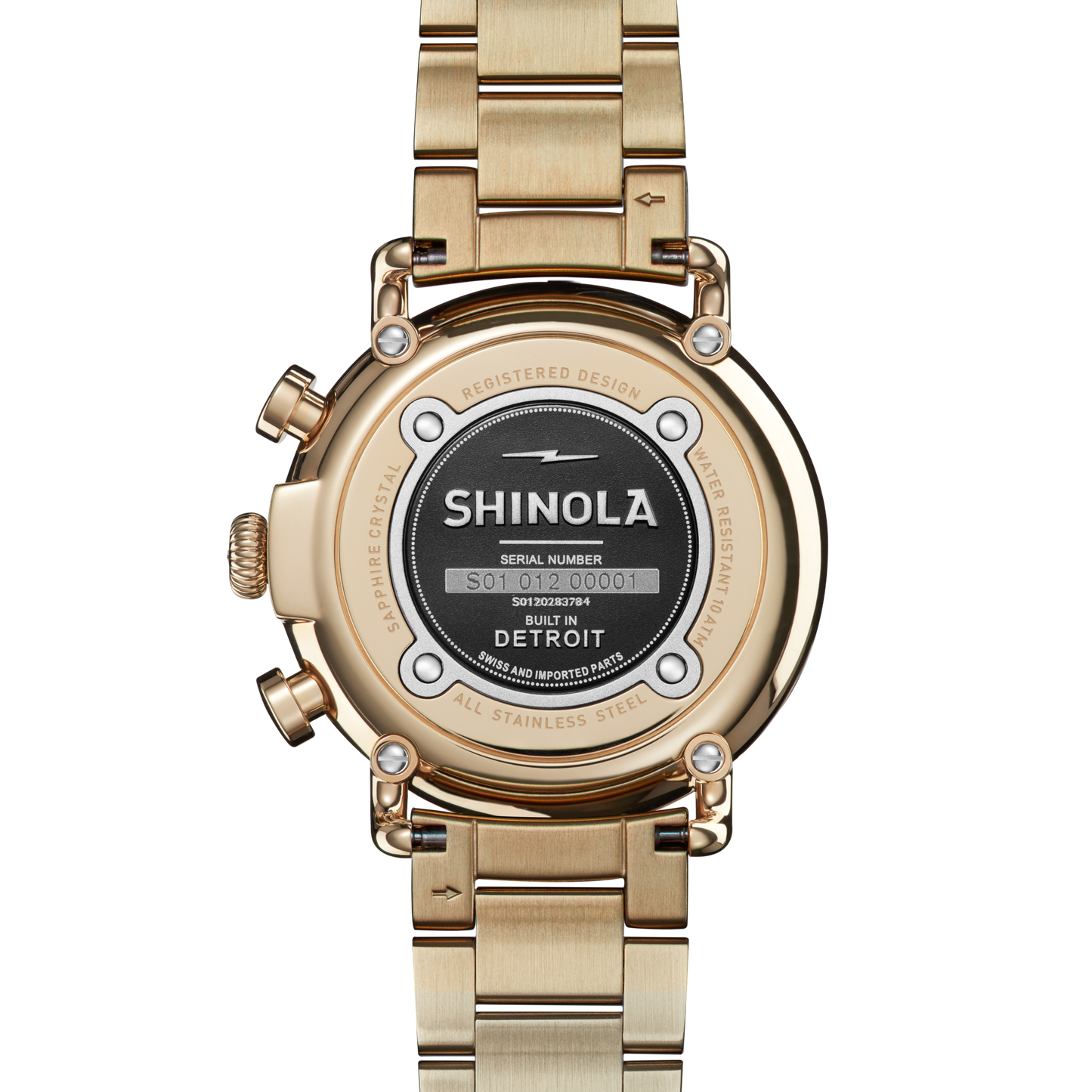 Back view of the Shinola Runwell Chronograph Watch - Ivory, showcasing a gold stainless steel bracelet, Shinola’s logo, serial number, “Built in Detroit,” and information on water resistance and design registration.