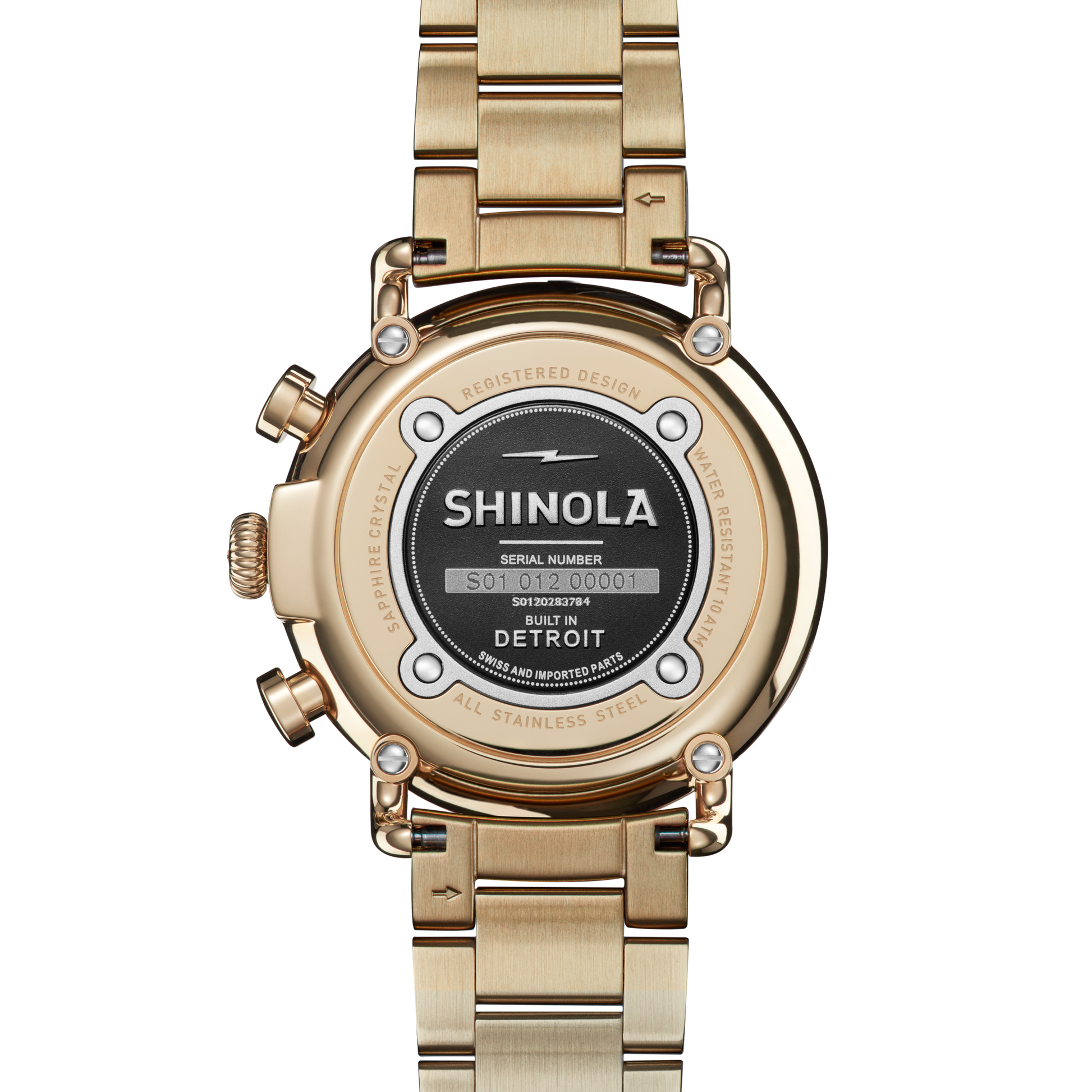 Back view of the Shinola Runwell Chronograph Watch - Ivory, showcasing a gold stainless steel bracelet, Shinola’s logo, serial number, “Built in Detroit,” and information on water resistance and design registration.