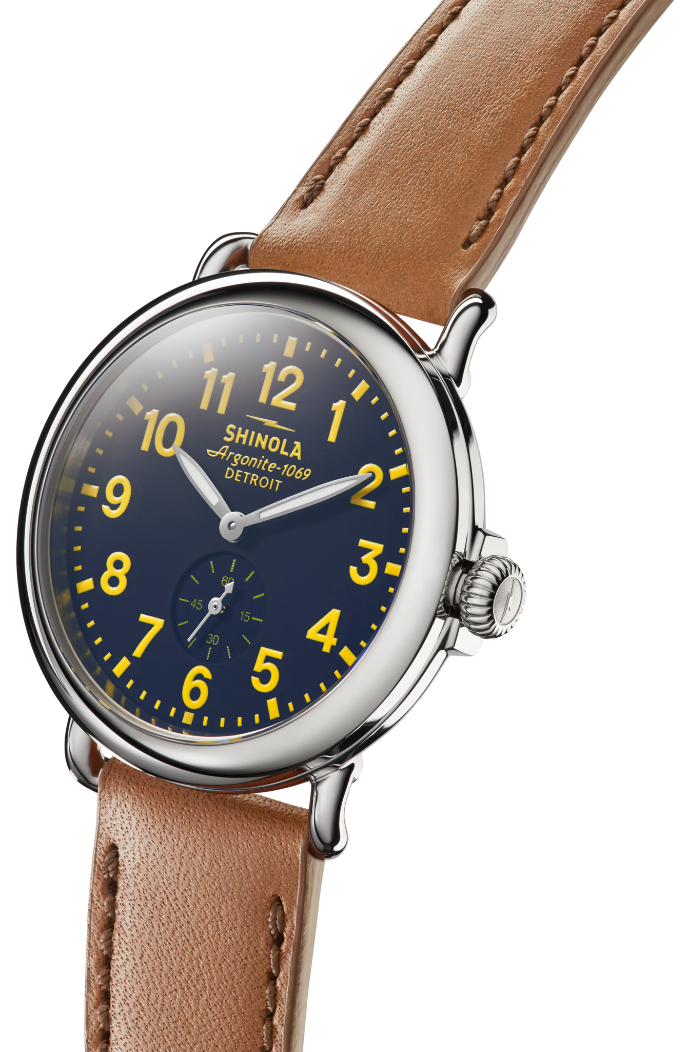 The Shinola Engravable Runwell Watch - Collegiate features a round dark blue face with yellow numerals, a small seconds subdial, brown leather strap, and polished silver case.