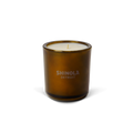 The Shinola Rose 8 oz Scented Candle features cream-colored coconut soy wax in a brown glass jar labeled “SHINOLA DETROIT.” With a subtle floral rose scent, it adds elegance to any space. Shown on a plain white background.