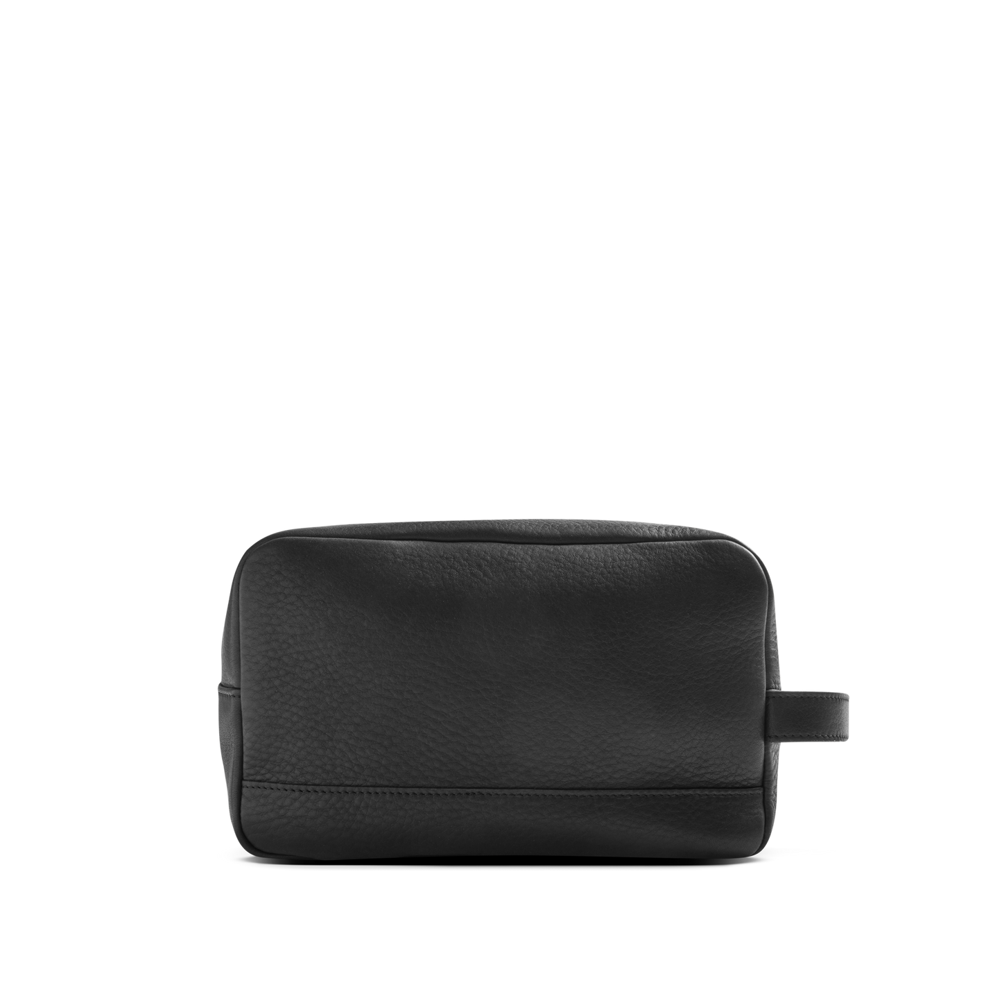 The Shinola Zip Travel Kit - Dominos is a black, rectangular travel kit crafted from natural grain leather with a textured finish, a small side handle, and water-resistant lining—shown on a plain white background.