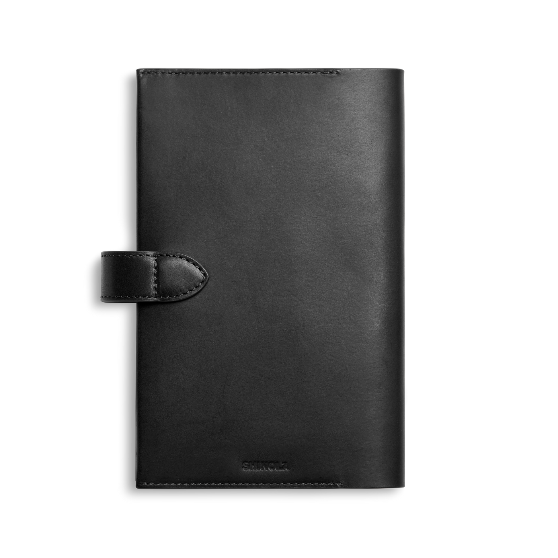 The Shinola Medium Snap Journal Cover in black Vachetta leather is shown closed, featuring a sleek finish and snap tab closure, set against a plain white background.