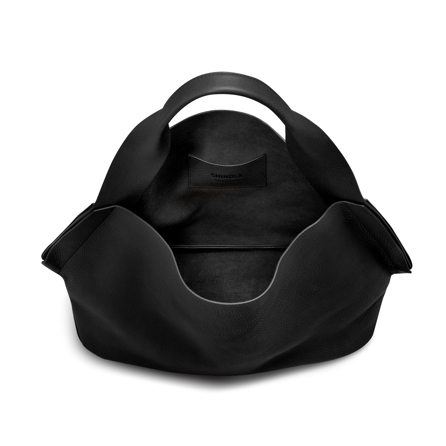The Derby Shoulder Bag - Black by Shinola is a spacious leather bag with a rounded handle, an exterior leather card pocket displaying the brand name, and a large open compartment for easy organization.