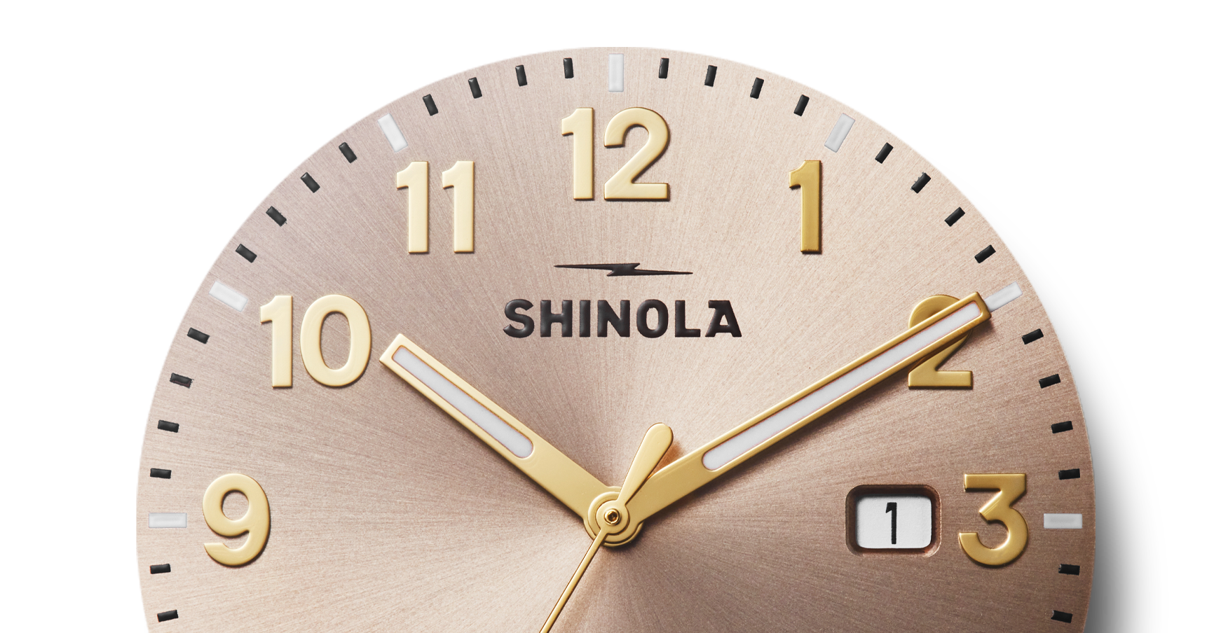 Close-up of a Shinola Detrola Watch - Nude, showing the time as 10:10. Features bold gold numbers, matching hands, and a date window at 1—showcasing classic American design and durable craftsmanship.