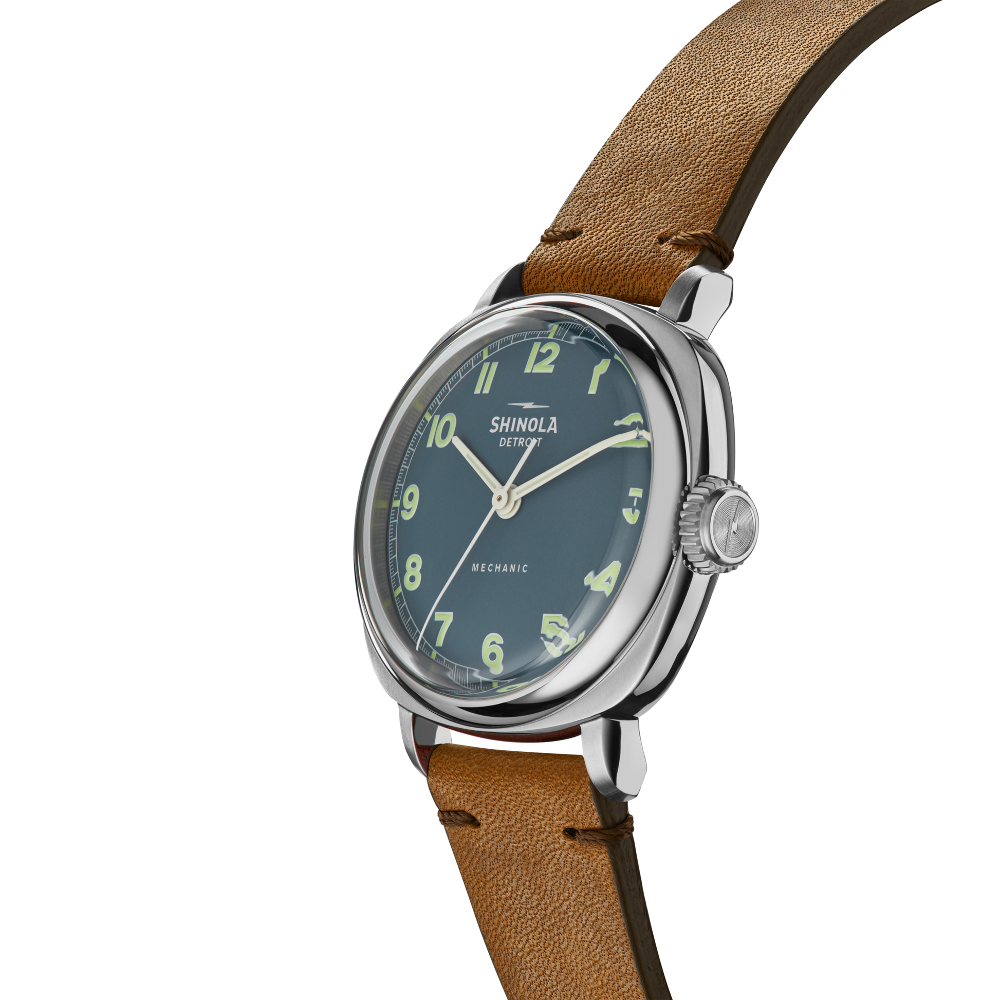 The Shinola Mechanic Watch - Steel Blue features a round blue face with luminous green numerals, a brown leather strap, and a polished metal case—showcasing classic throwback design and hand-wound mechanical movement.