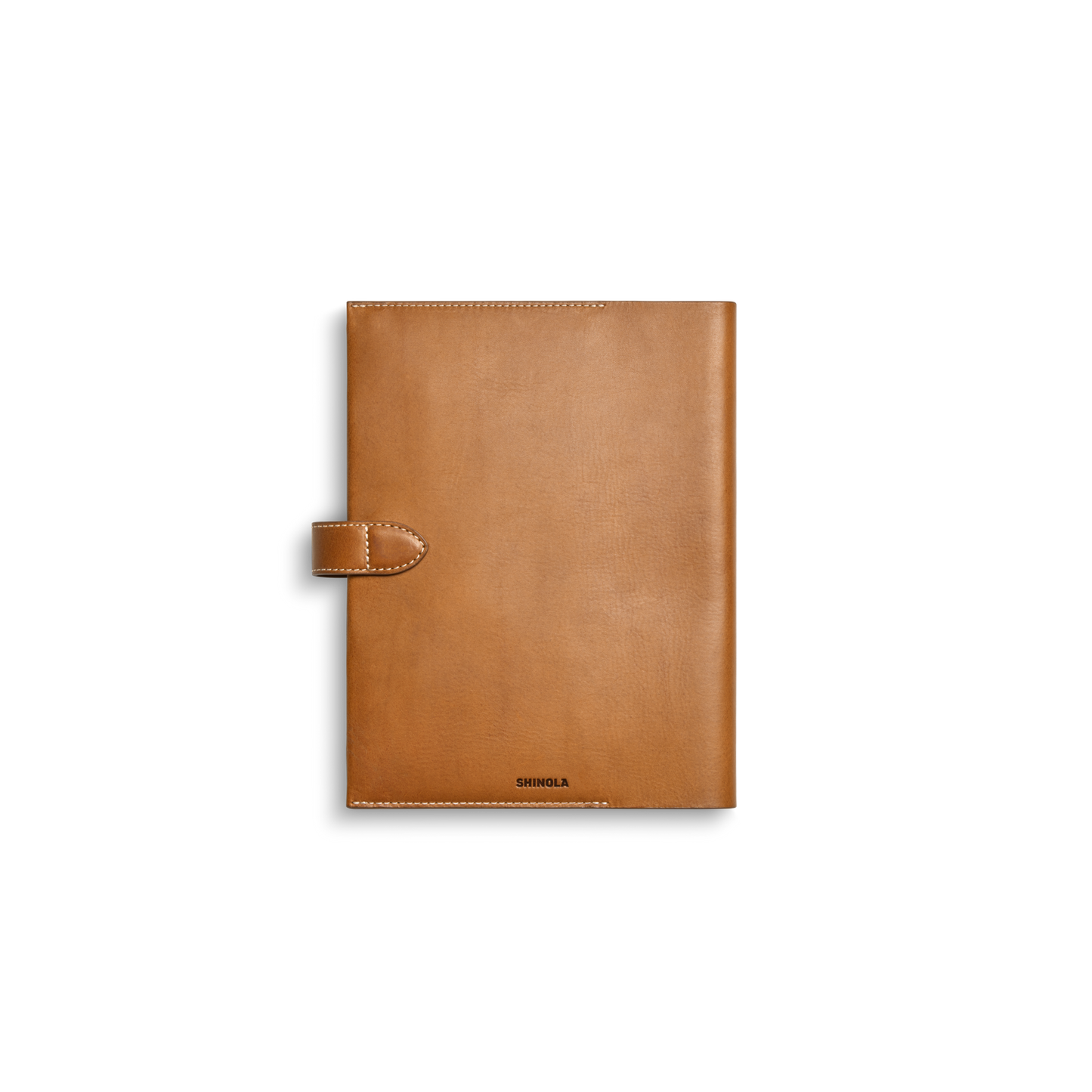 The Large Journal Cover - Tan by Shinola features Italian Vachetta leather, stitched edges, a left snap closure, and “Shinola” embossed at the bottom center, shown on a white background.