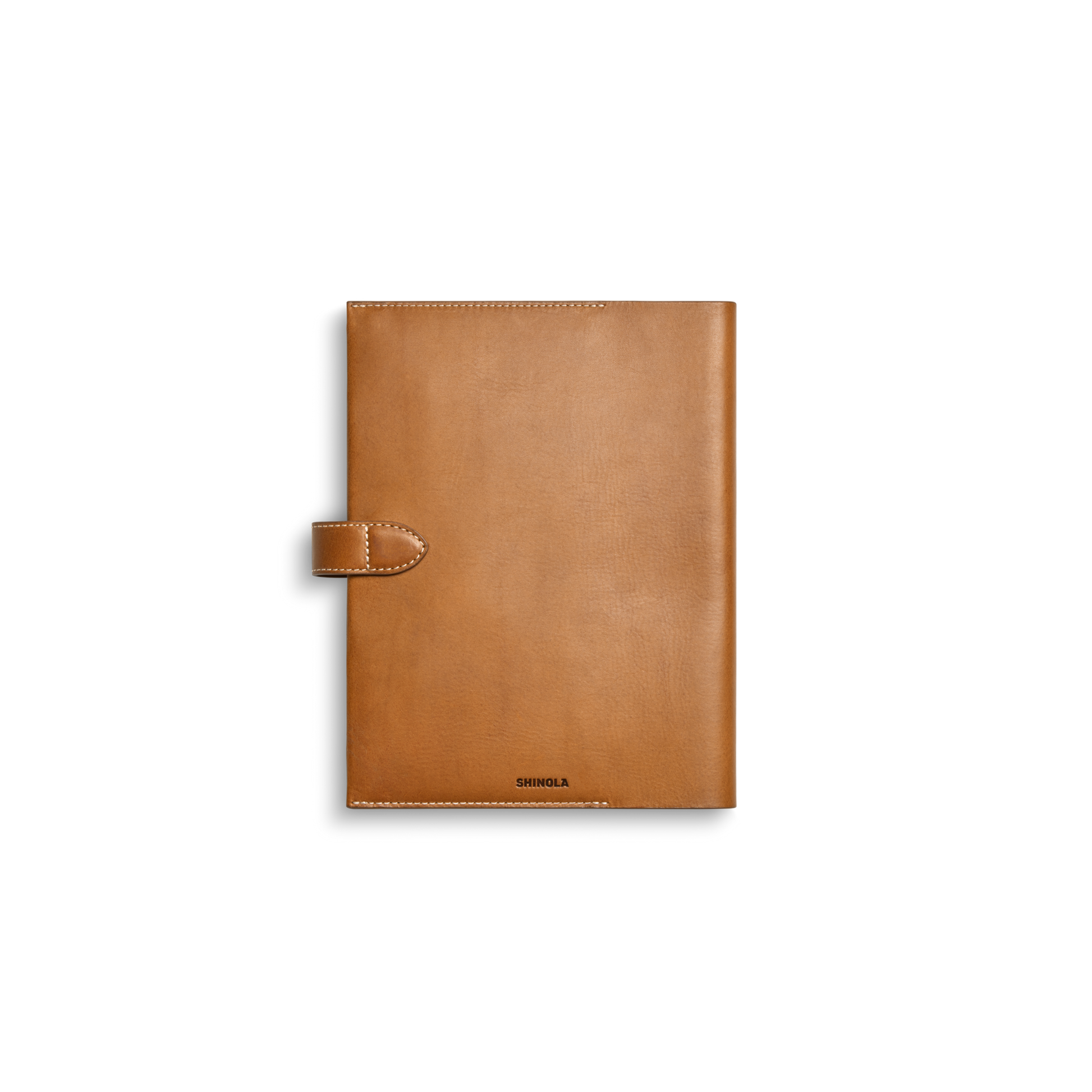 The Large Journal Cover - Tan by Shinola features Italian Vachetta leather, stitched edges, a left snap closure, and “Shinola” embossed at the bottom center, shown on a white background.