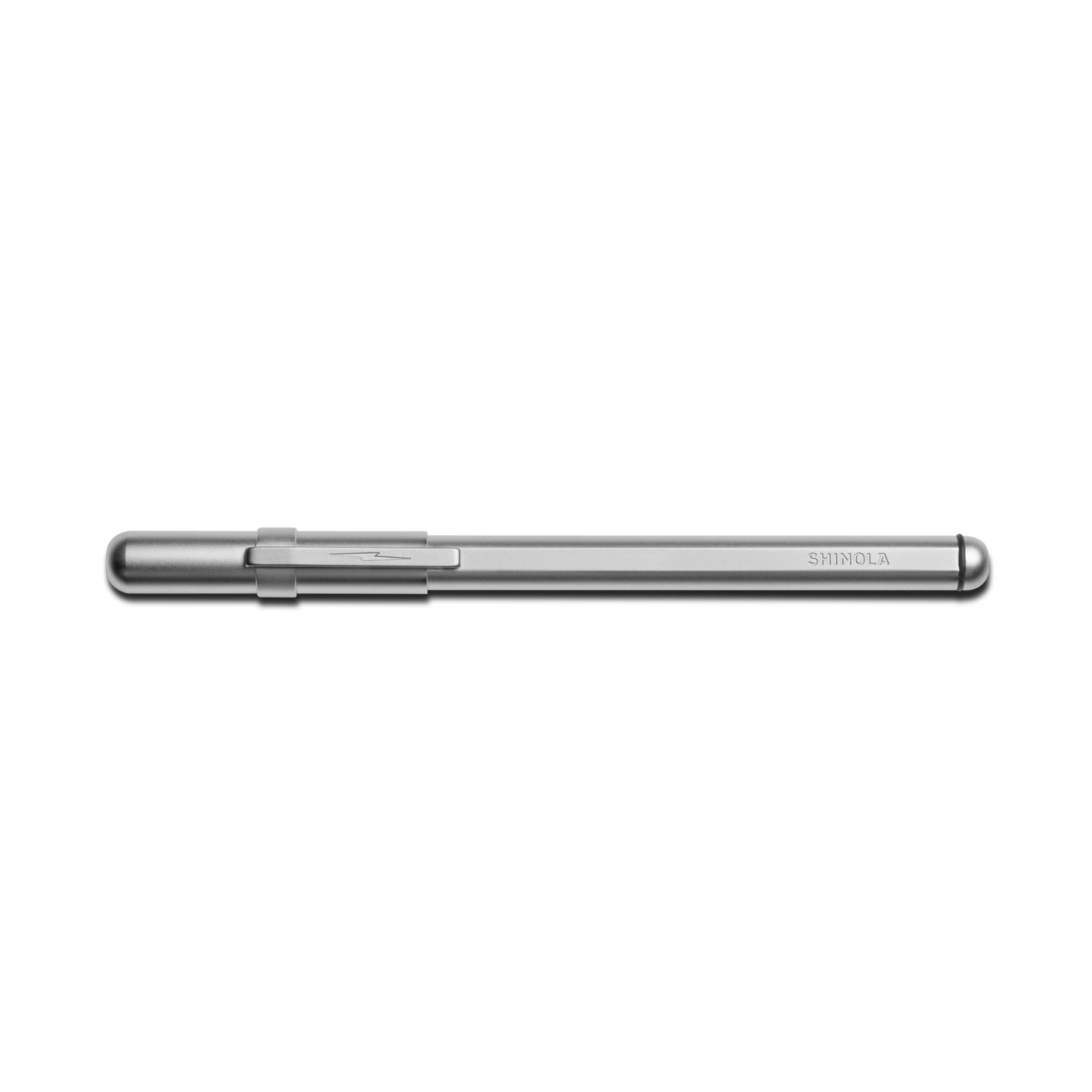 A matte silver Stainless Steel Studio Pen by Shinola with a clipped cap rests horizontally on a white background. The SHINOLA brand name is engraved near the end of this elegant pen's stainless steel barrel.