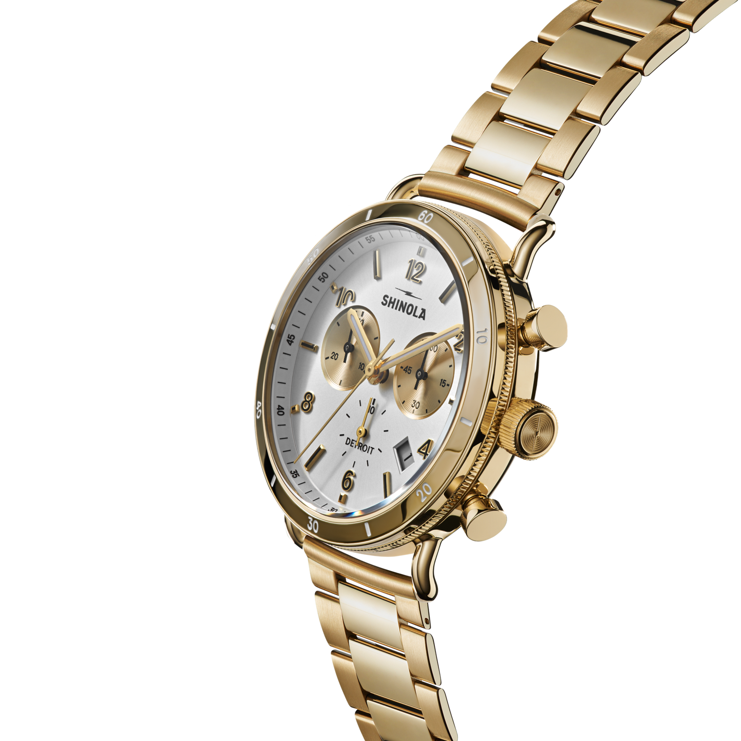The Shinola Canfield Sport Watch - Gold Dominos features a white dial with gold subdials and a gold stainless steel link band, shown angled against a white background.