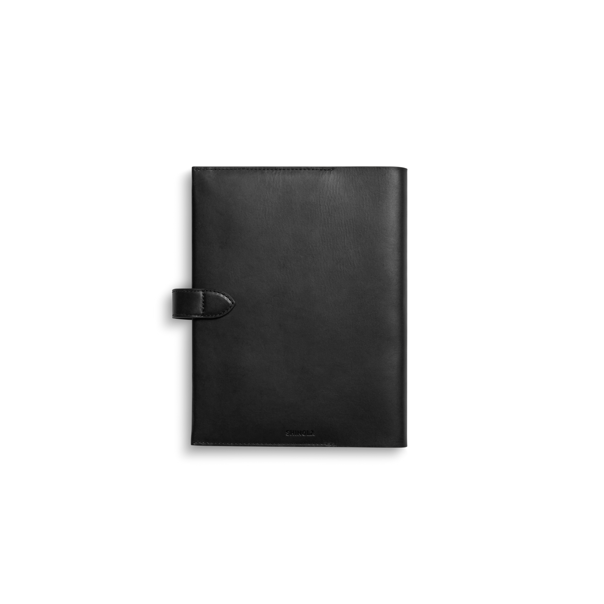 The Shinola Large Journal Cover in black features a strap closure and is crafted from Italian Vachetta leather, shown against a plain white background.