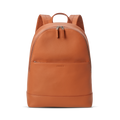 The Shinola Canfield Backpack in Rust is a sleek orange leather bag with a front zip pocket, dual zipper pulls on the main compartment, and padded shoulder straps—perfect for stylish travel—shown against a plain white background.