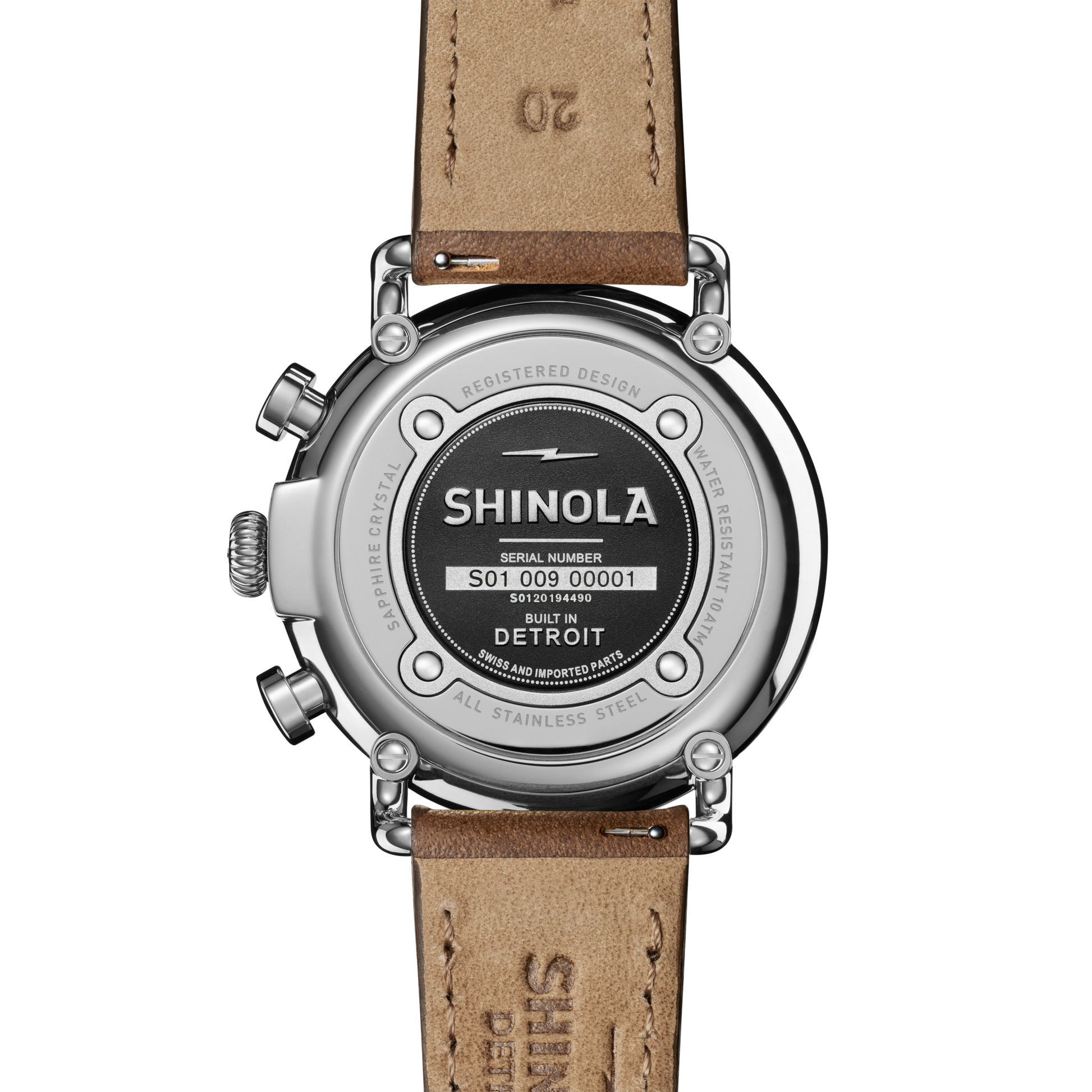 Close-up of the Shinola Runwell Chronograph Watch - Midnight Blue, featuring a brown leather strap and stainless steel case etched with the logo, serial number, and details showing it's built in Detroit with Swiss parts.
