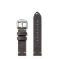 The image shows two pieces of the Shinola 20mm Grizzly Black Leather Watch Strap: one with a silver buckle, the other with a pointed tip and multiple holes. The hand-sewn strap, in Grizzly Black, is crafted in the USA and photographed against a white background.