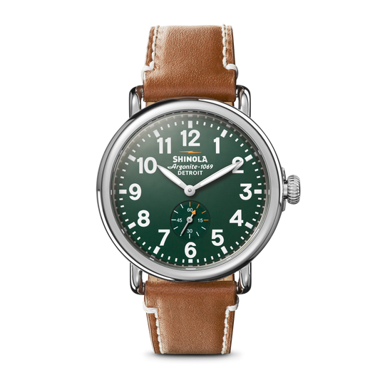 The Shinola Engravable Runwell Watch - Green features a green dial with white numerals, silver case, brown leather strap, the Shinola Detroit logo on the dial, and a small seconds subdial above 6 o’clock.