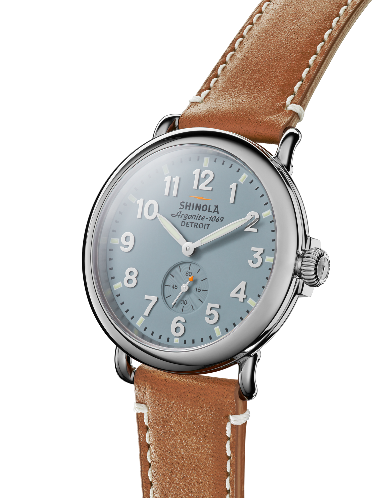 The Shinola Runwell Watch in Gray/Blue features a slate blue dial with white numerals and a brown leather strap with white stitching, displayed at an angle on a white background.