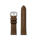 Two Shinola 24mm Dark Nut Brown Leather Watch Straps, crafted from genuine leather with silver buckles, are displayed side by side; the left shows a buckle and two loops, while the right features multiple holes for size adjustment.