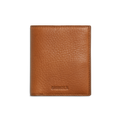The Shinola Coin Bifold - Tan is a slim, textured natural grain leather wallet with SHINOLA embossed near the bottom center, shown closed on a plain white background. It offers refined style and lasting durability.