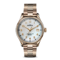 The Shinola Vinton Watch features a gold metal link band, white mother-of-pearl dial, gold hour markers and hands, date window at 3 o’clock, and “Shinola” plus “Argonite-715 Detroit” on the face—a statement of modern sophistication.