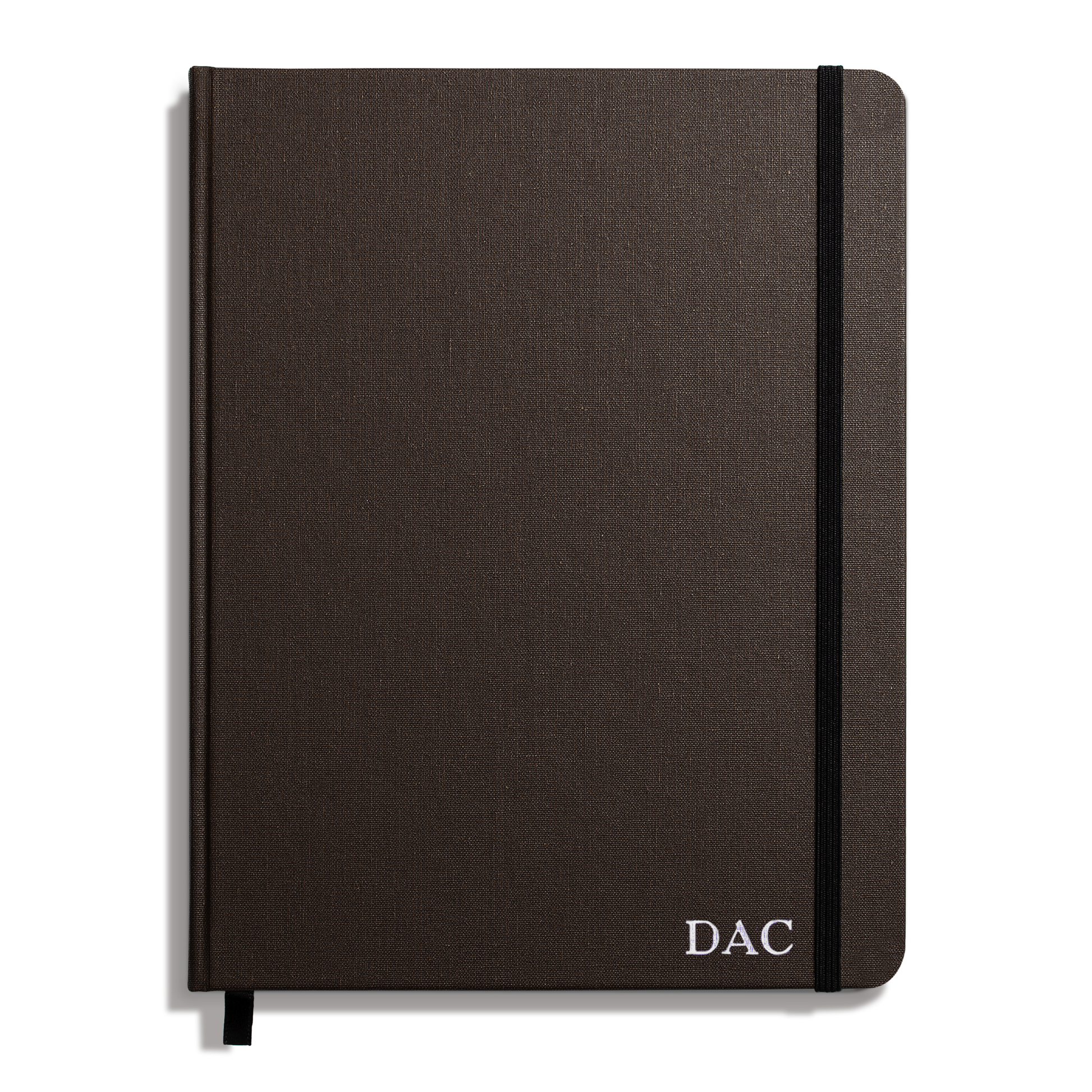 The Shinola Large Hard Ruled Journal in Espresso features a dark brown linen cover, hard Smyth-sewn binding, black elastic band, ribbon bookmark, and white "DAC" initials printed on the bottom right corner.
