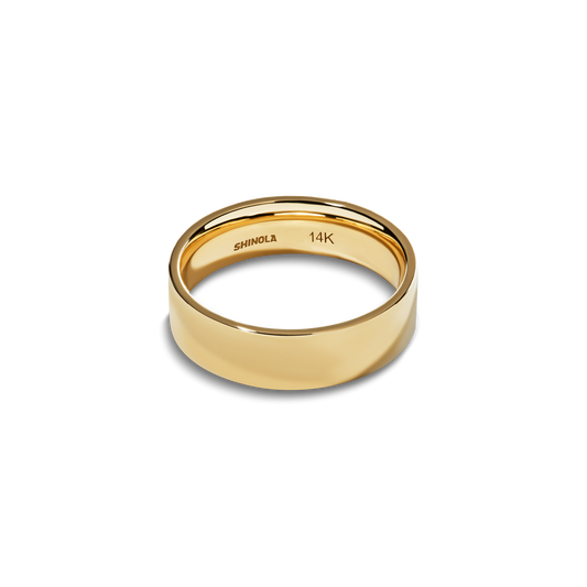 The Shinola 6mm Flat Yellow Gold Band features a smooth, flat-cut 14k yellow gold surface with “SHINOLA” and “14K” engraved inside, elegantly presented on a white background.