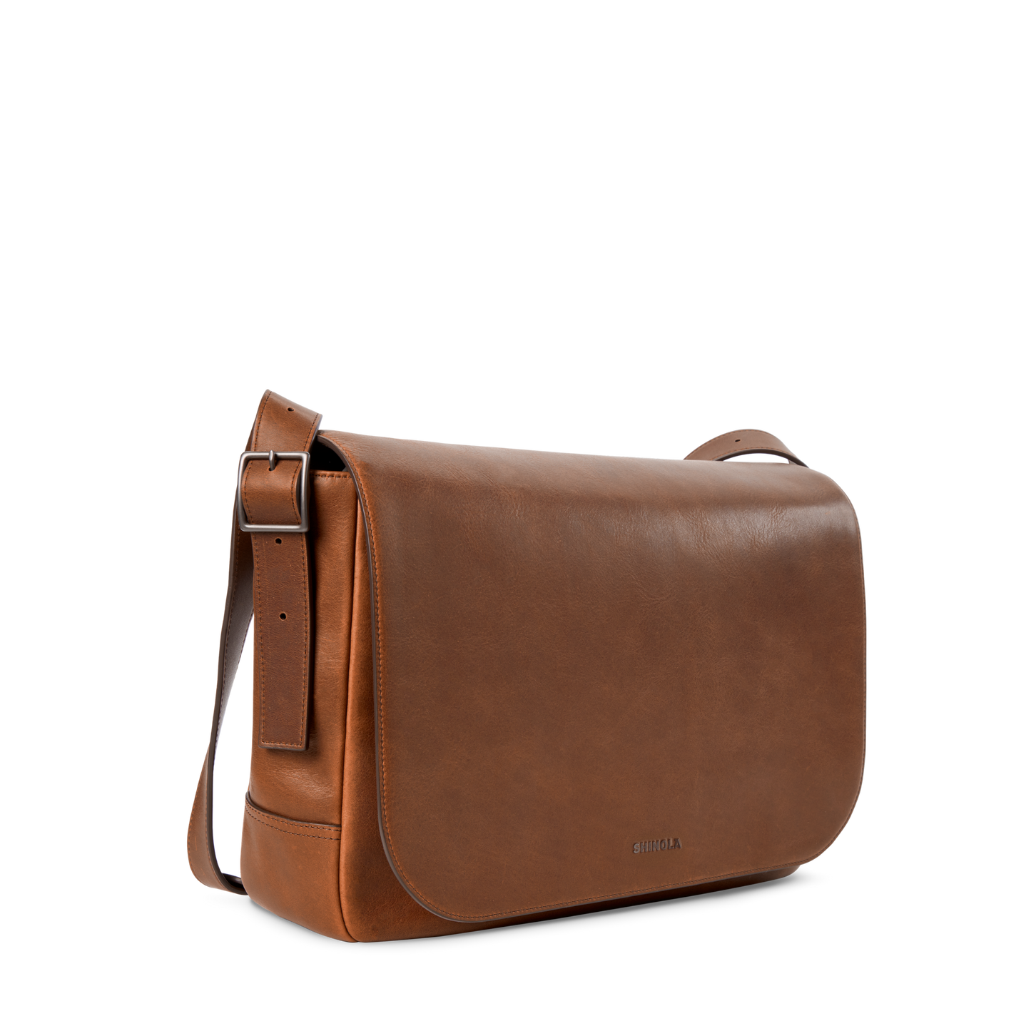 The Shinola Runwell Messenger Bag in medium brown features a large front flap, adjustable crossbody strap, and minimalistic design, displayed on a plain white background.