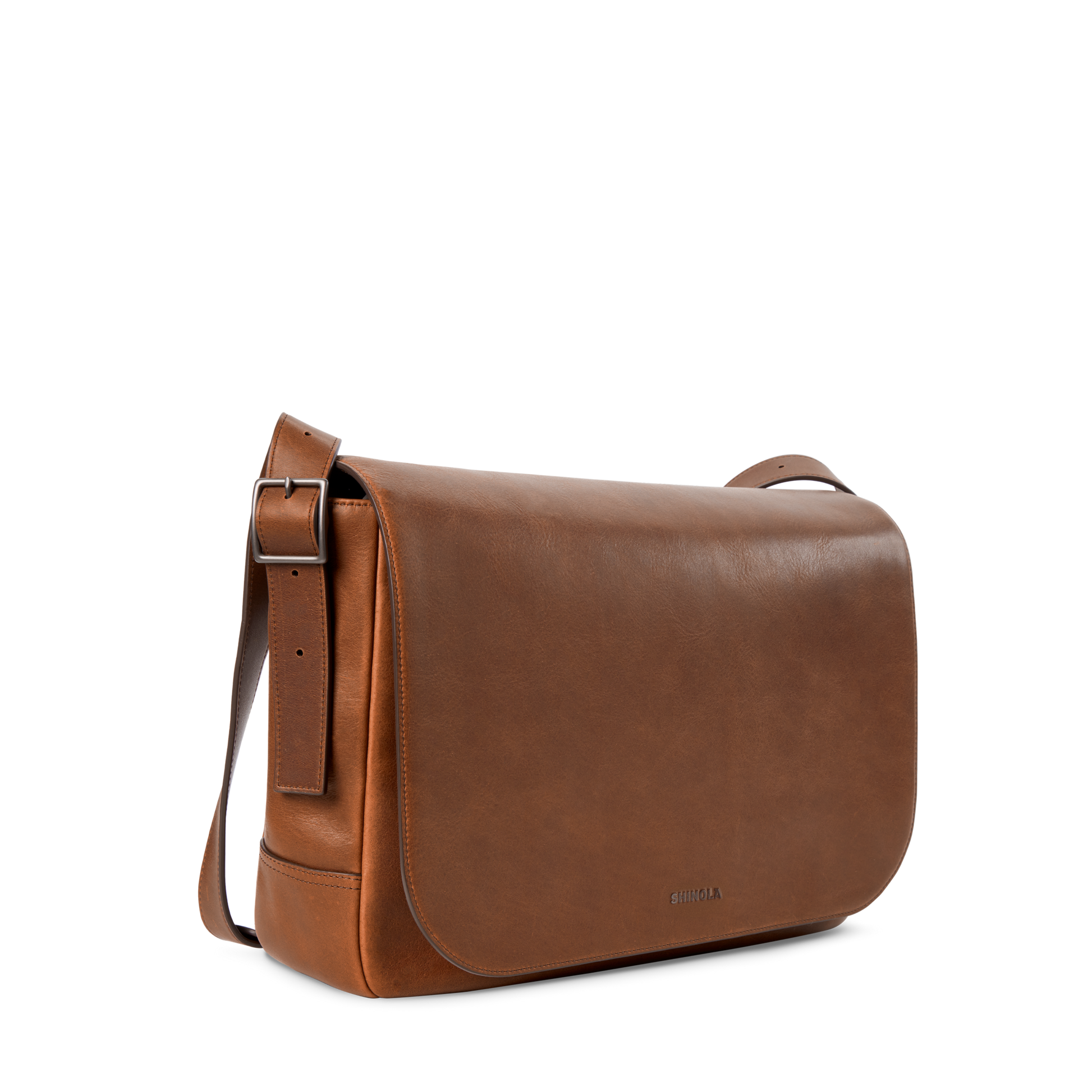 The Shinola Runwell Messenger Bag in medium brown features a large front flap, adjustable crossbody strap, and minimalistic design, displayed on a plain white background.