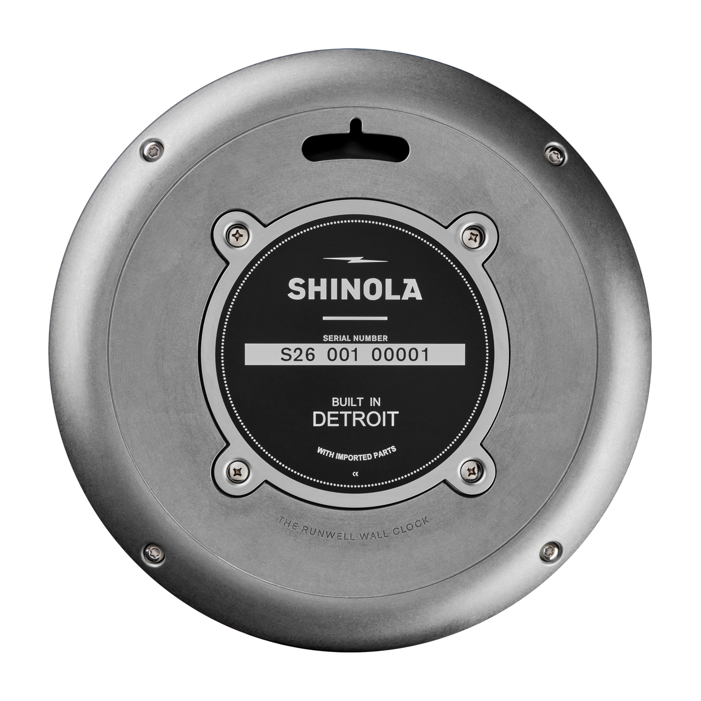 Back view of the Shinola 14" Runwell Clock in Tumbled Zinc/Black shows its industrial design with a tumbled zinc case, serial number S26 001 00001, "Built in Detroit" on the black label, and four screws securing the plate.