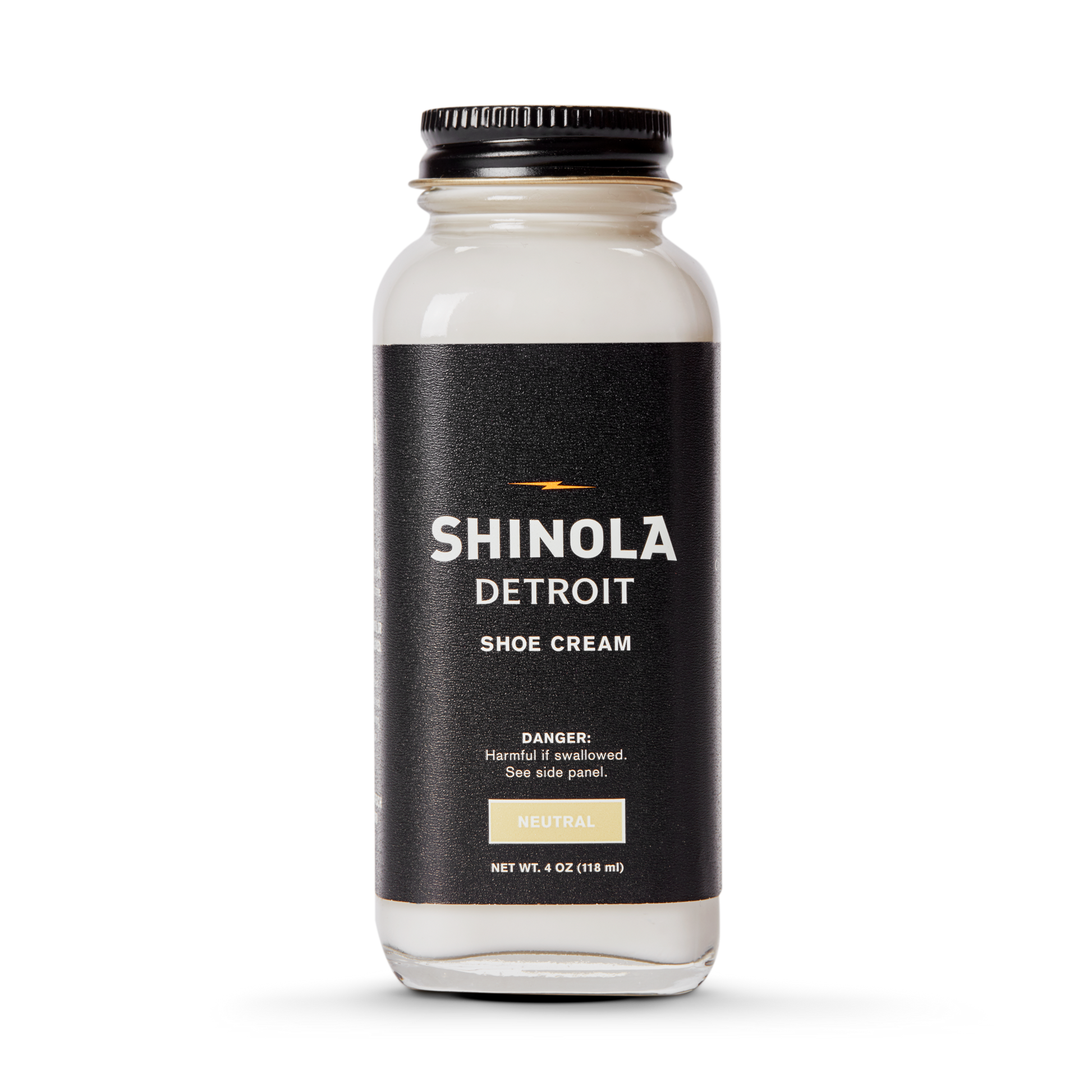 A clear glass jar of Shinola Shoe Cream - Neutral with a black lid and label featuring white and gold text, warning it is harmful if swallowed.