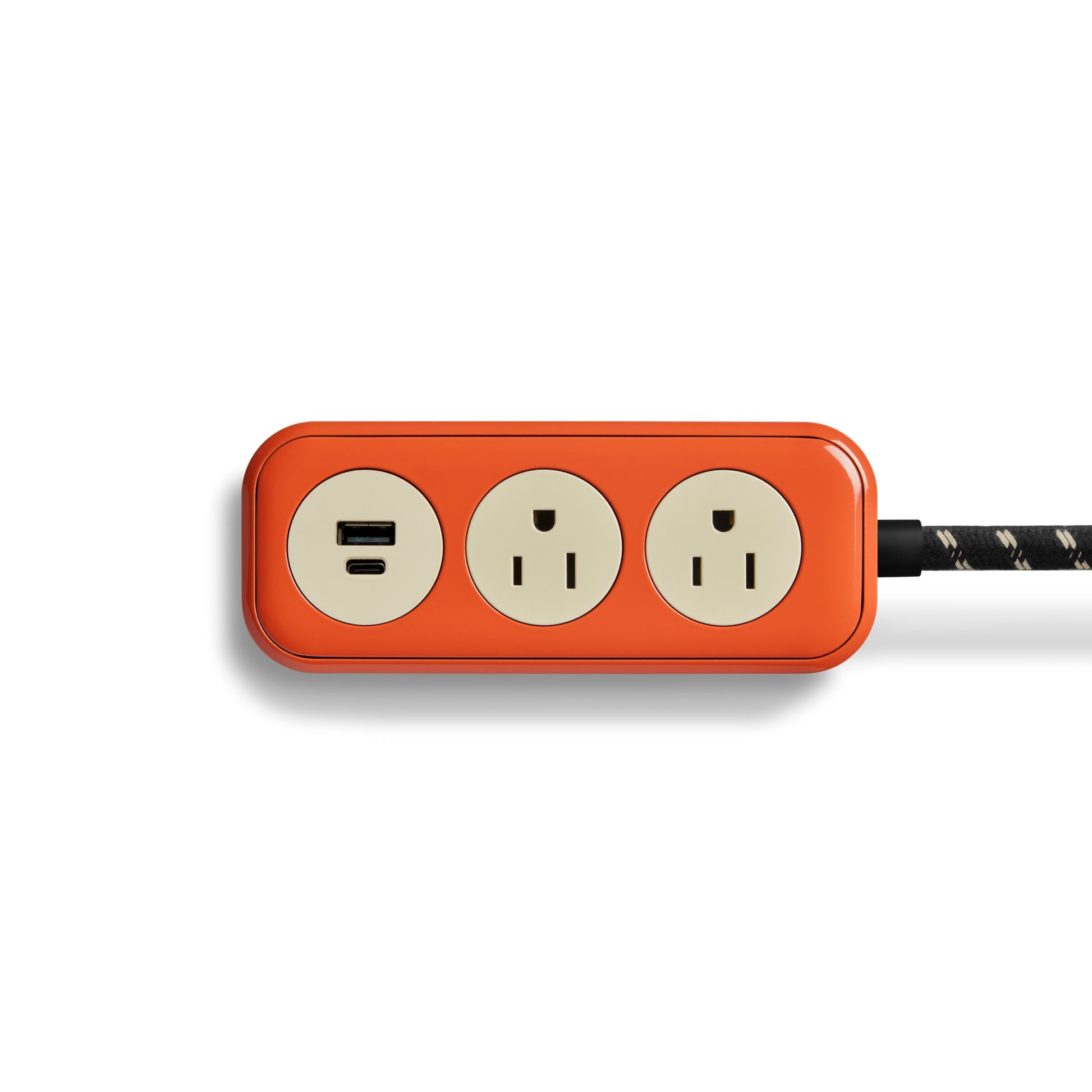 The Shinola 2 Port Power Supply - Tangerine is a red rectangular power strip featuring two electrical outlets, fast-charging USB-A and USB-C ports, and a durable braided cord, shown on a white background.