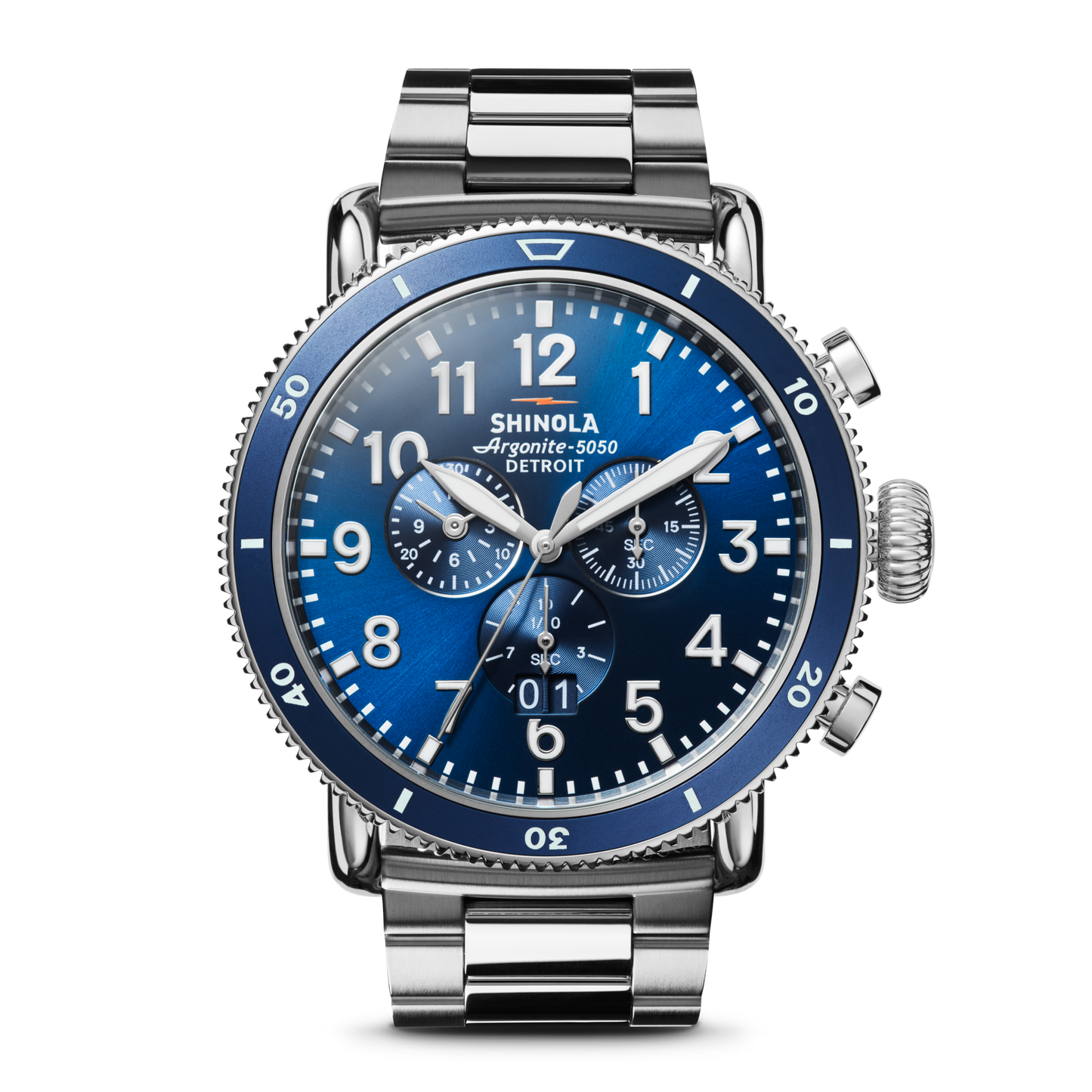 The Shinola Runwell Sport Chronograph Watch - Midnight Blue features a stainless steel case and bracelet, blue dial with white numerals, three subdials, and two side pushers, shown against a white background.
